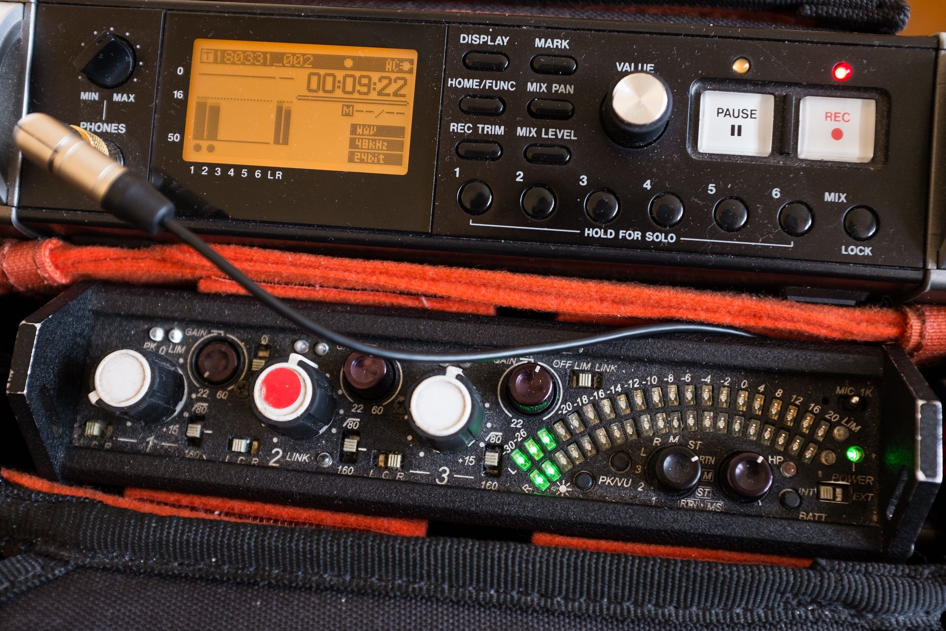 Audio recording kit, sound mixer and recorder in a portable bag, red REC button on and green stereo led peak meter illuminated